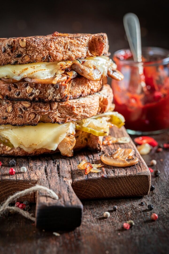 Rustic and unhealthy toasts with cheese, mushrooms and onion.