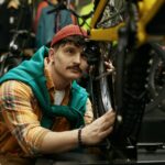 Hipster man selecting new mountain bike in shop