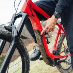 Man connecting an electric mountain bike