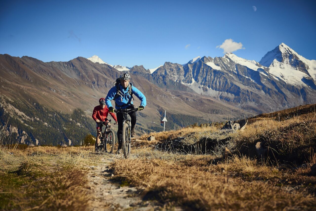Mountain bikers on dirt track, Valais, Switzerland