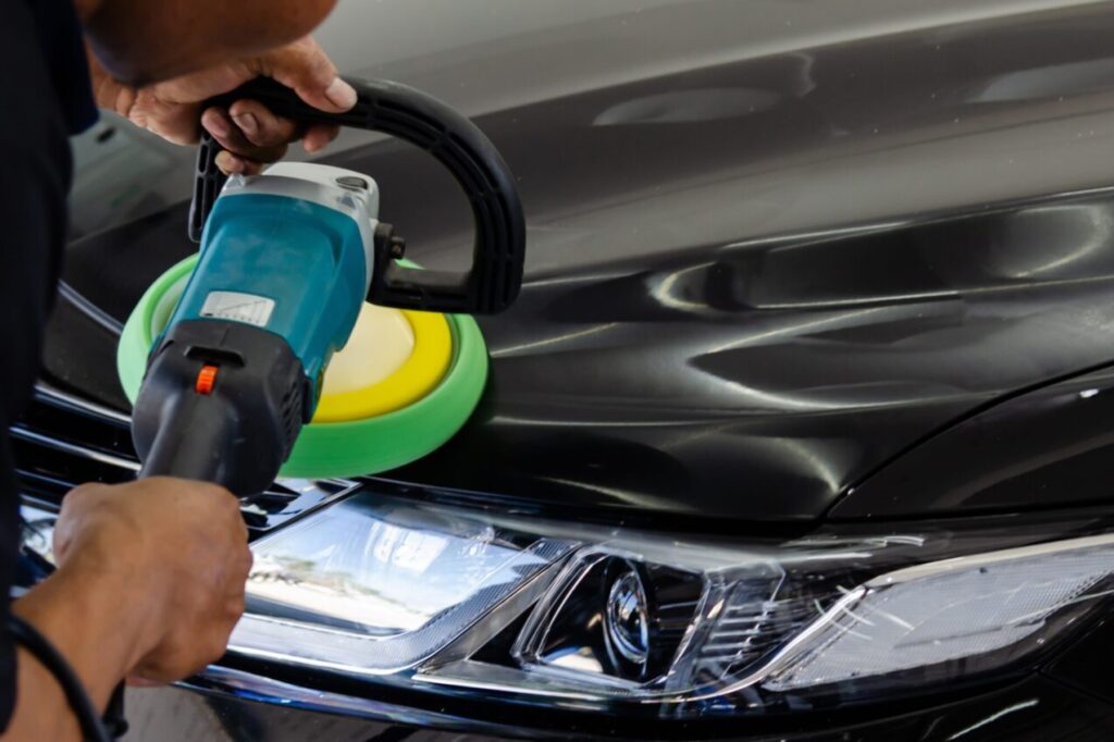 Car detailing.Man hand holding and polish the car.Polishing car wax.