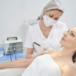 Doctor performing laser mole removal procedure in beauty clinic