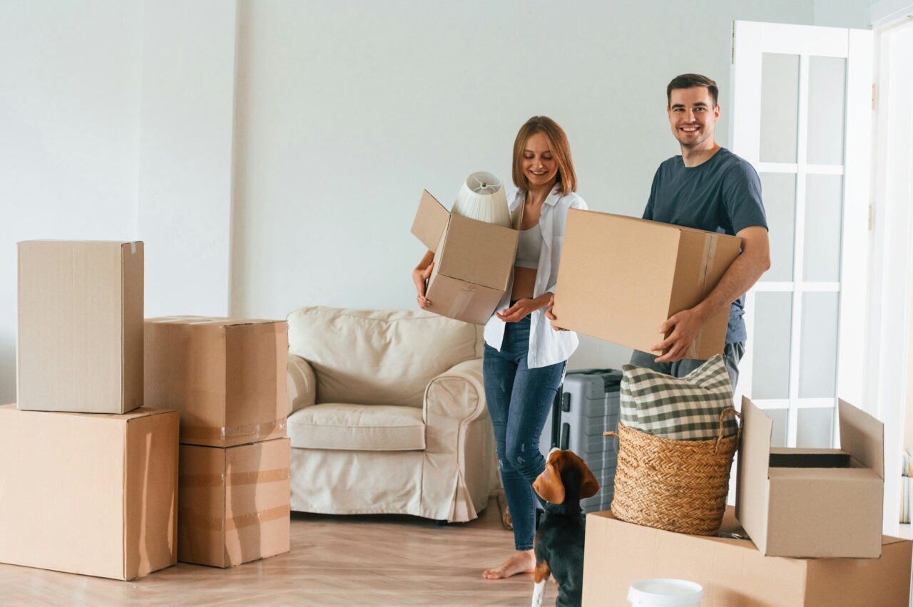Bright big appartment. Young couple with dog are moving to new home
