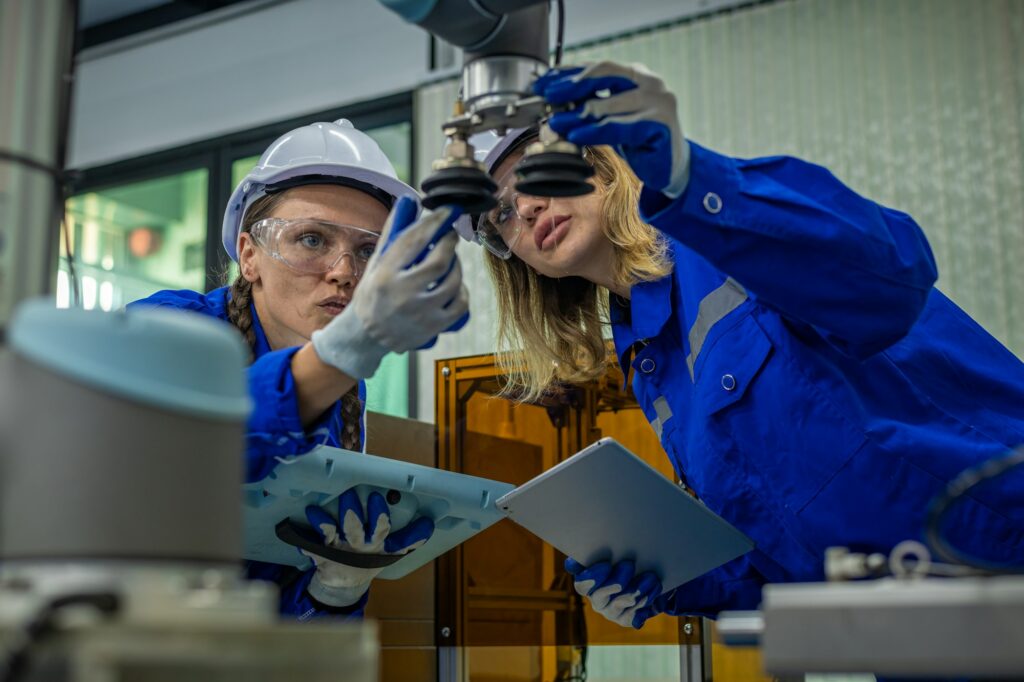 Engineer factory industry wearing safety uniform work and checking system of the welding robots for