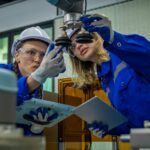 Engineer factory industry wearing safety uniform work and checking system of the welding robots for