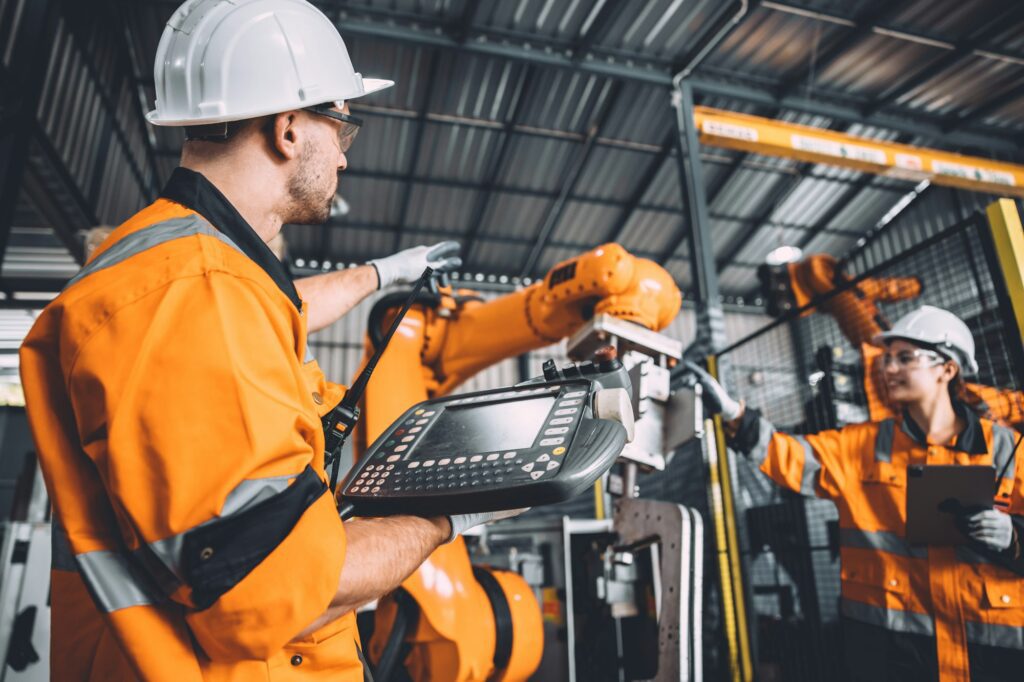 Engineer team service robot welding working in automation factory manufacturing industry technology.