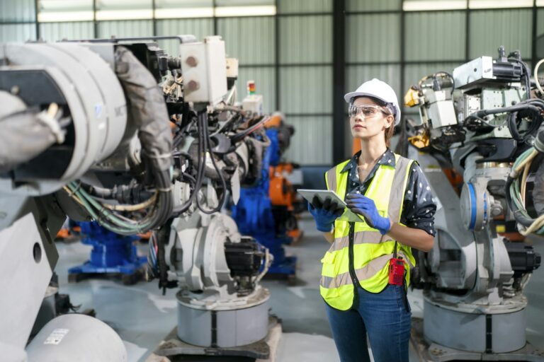 Industrial factory workers working in metal manufacturing industry.
