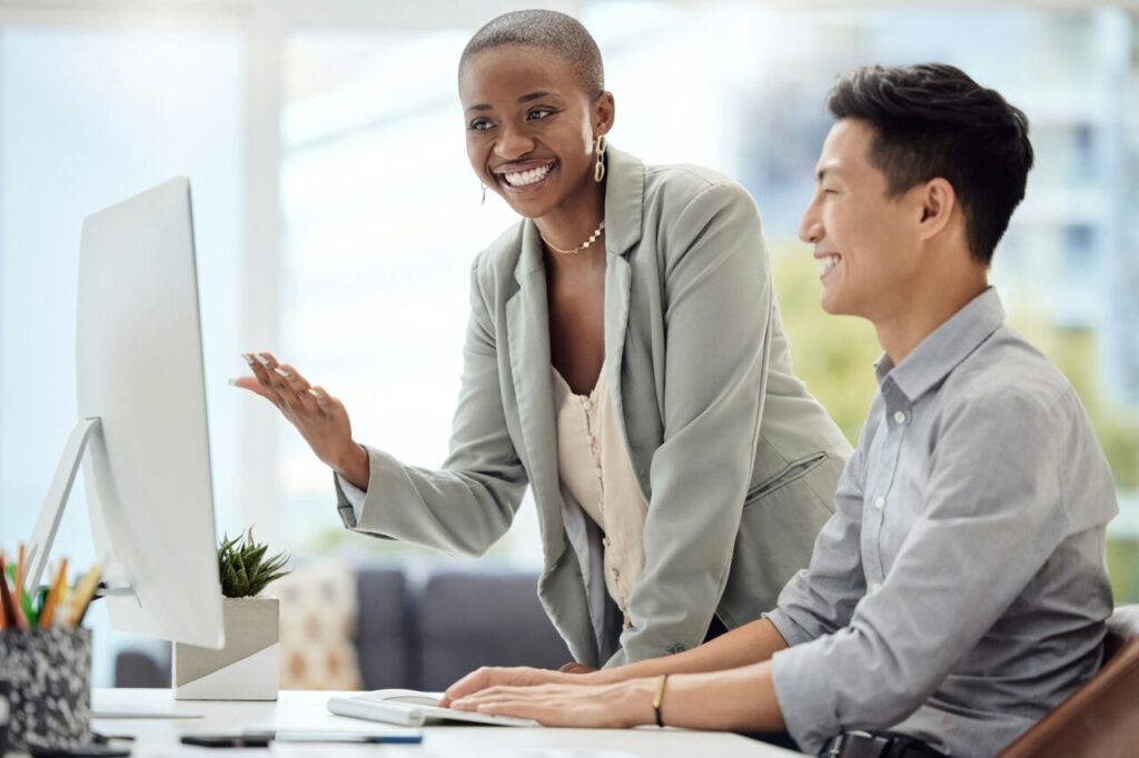 Mentor, manager and teamwork with a business woman training a male employee in the office. Meeting,