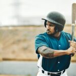 Baseball player, training and bat for fitness workout on outdoor sports field. Serious athlete batt