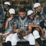 Baseball, sport and phone with a team of men on a bench after training, practice or a game. Teamwor