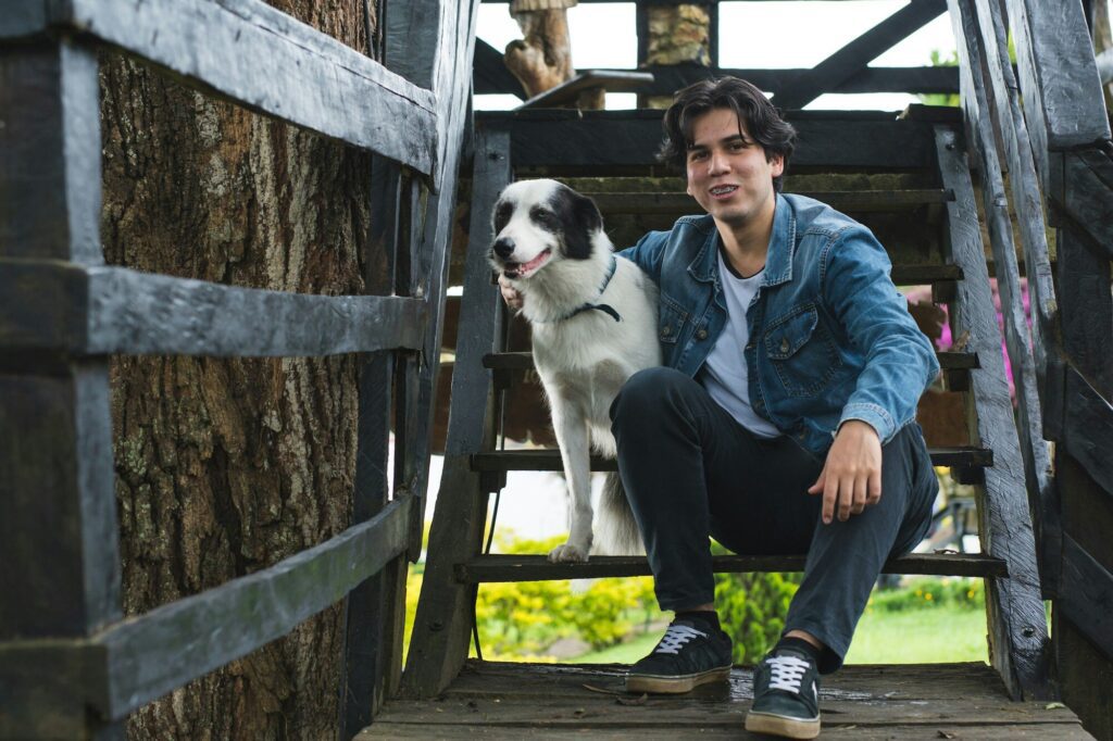 teenager with acne and braces, confident, self-assured and optimistic with his pet