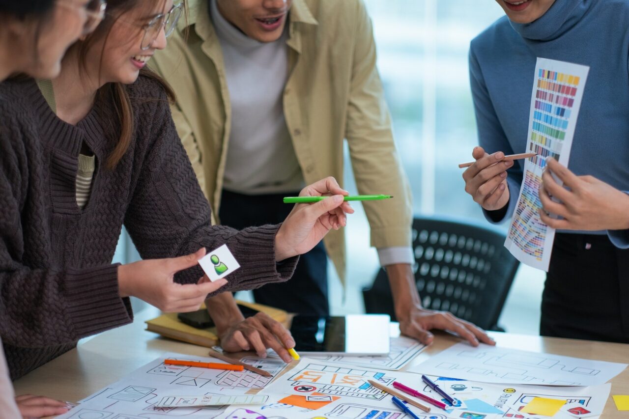 creative digital development agency brainstorming about mobile app interface wireframe design on
