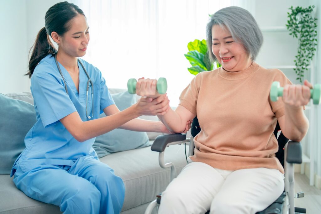 Asian nurse or doctor who work as homecare support staff help senior woman exercise