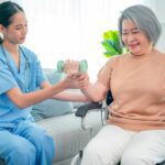 Asian nurse or doctor who work as homecare support staff help senior woman exercise