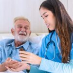 Caregiver nurse take care a Senior patient. Nurse helping senior Man
