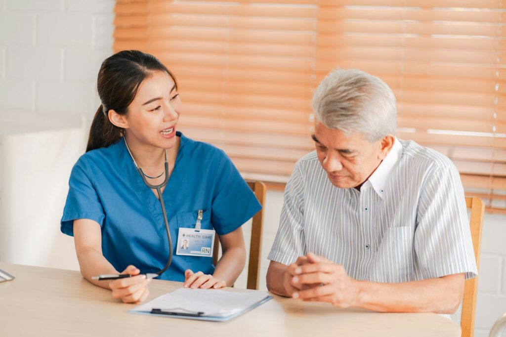 Health insurance service, Young Asian caregiver nurse examine senior man or woman patient at home