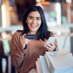 Shot of a young woman making online payments using her smartphone