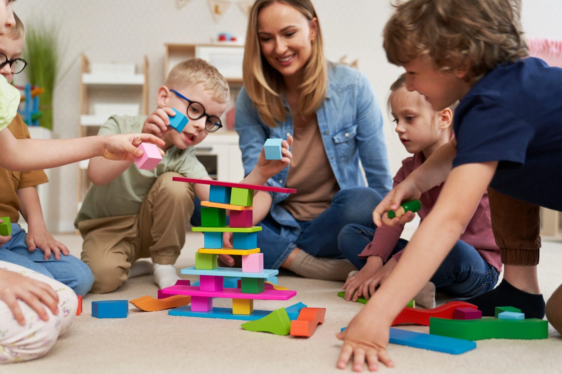 Children playing with toy blocks in the kindergarten