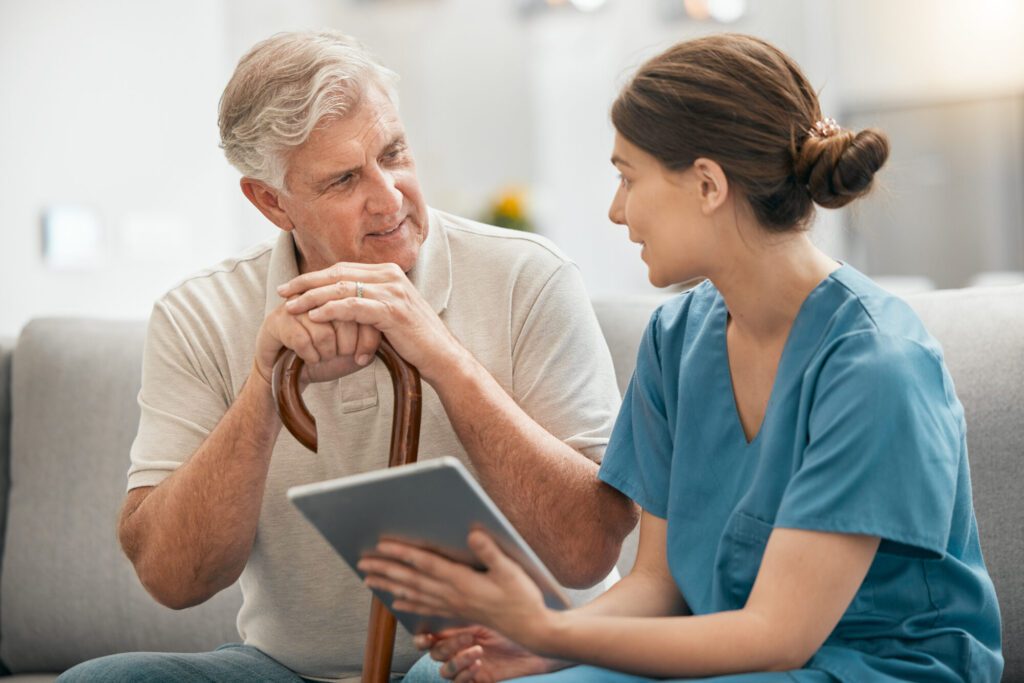 Woman, nurse and tablet in elderly care, consultation or visit in retirement home for healthcare ad